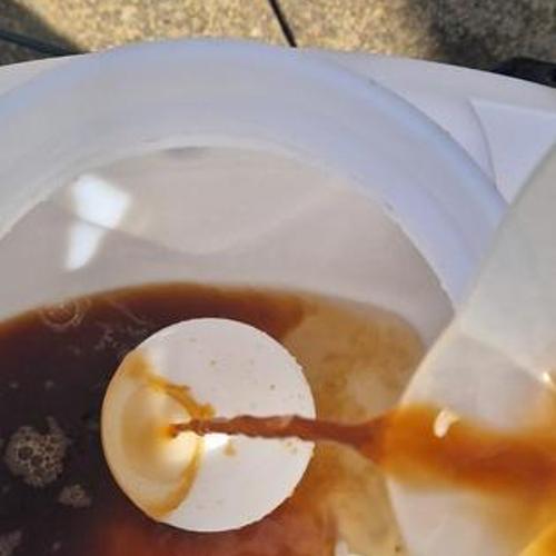 Pouring seaweed into sprayer