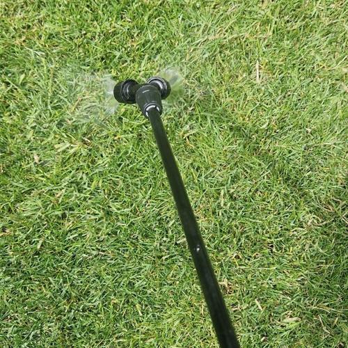 Spraying lawn with seaweed feed